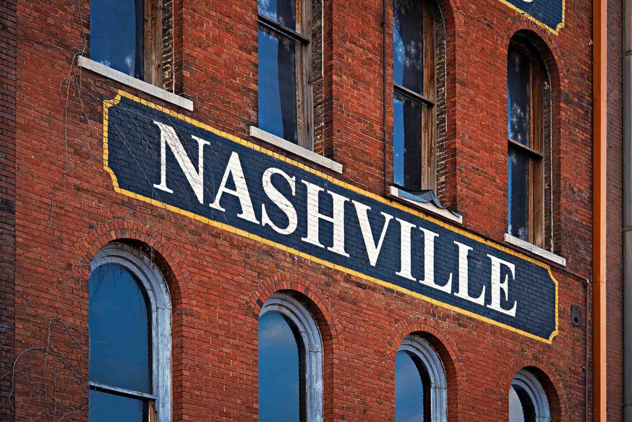 The word Nashville painted on a side of red brick building in Nashville, Tennessee.