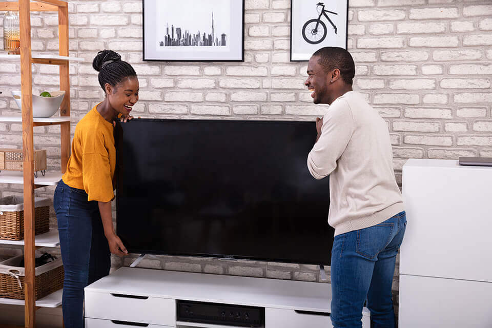 couple moving a tv