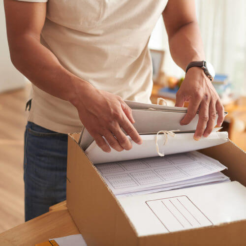 man packing documents