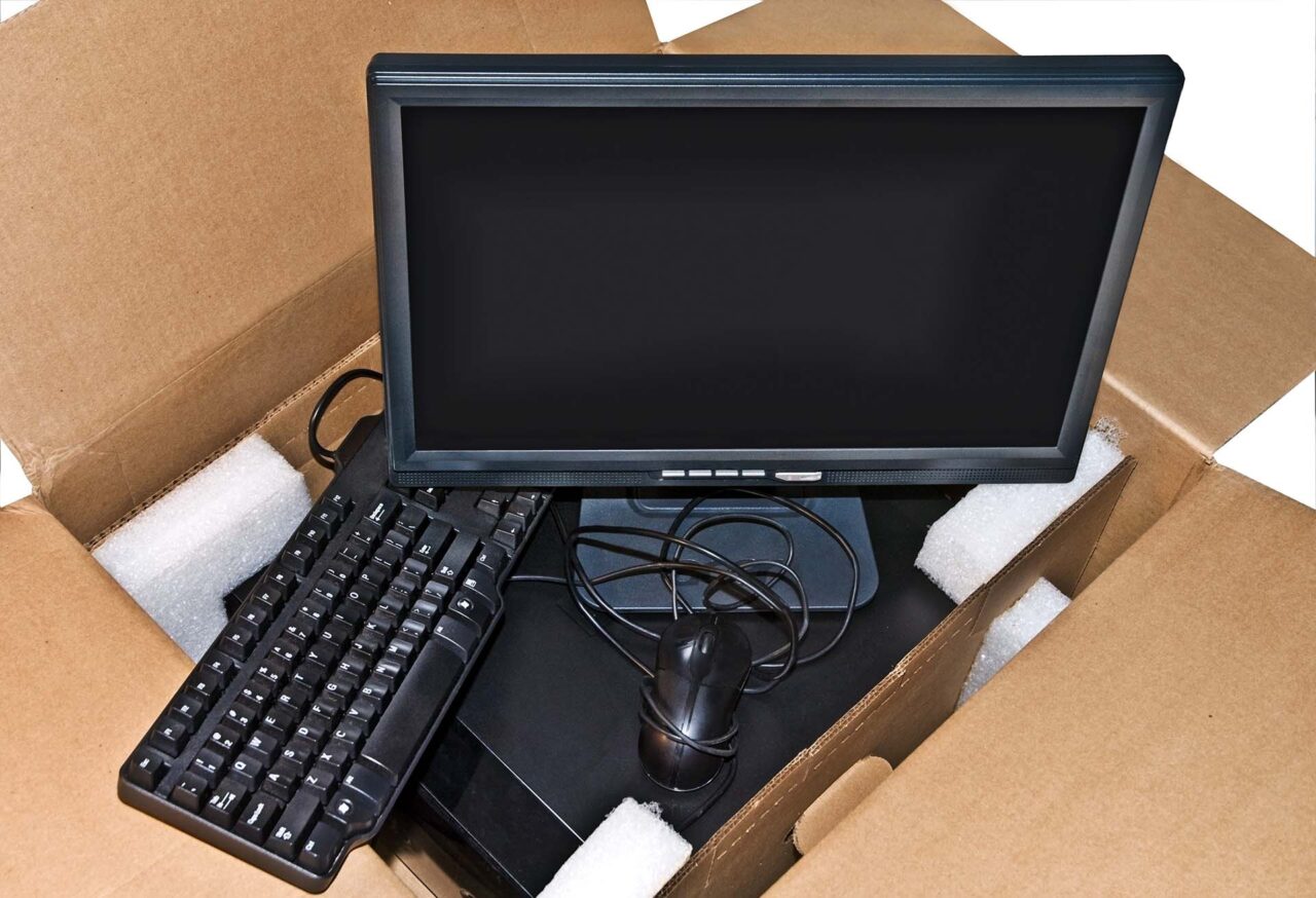 Components of a new computer system in a cardboard box.