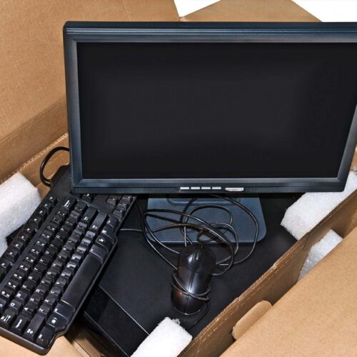 Components of a new computer system in a cardboard box.