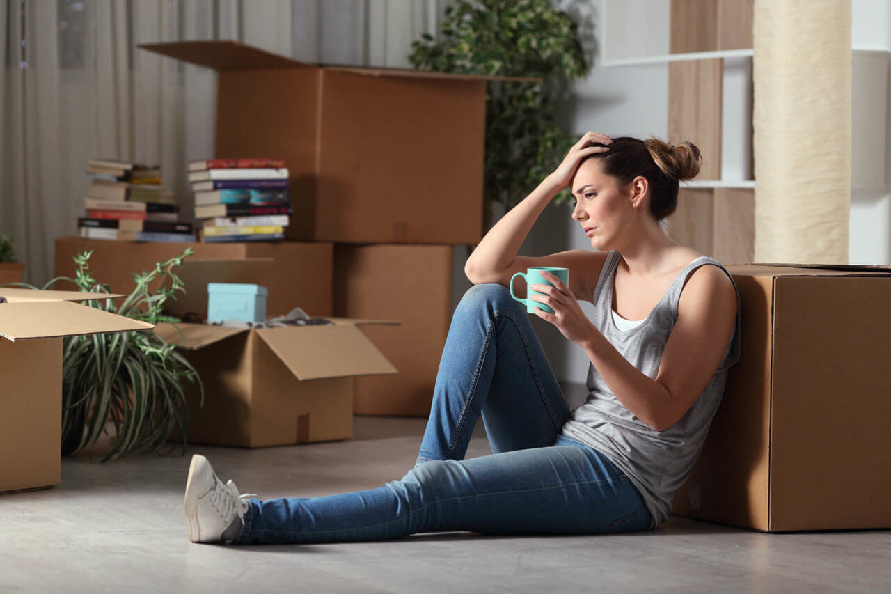 worried girl with moving boxes
