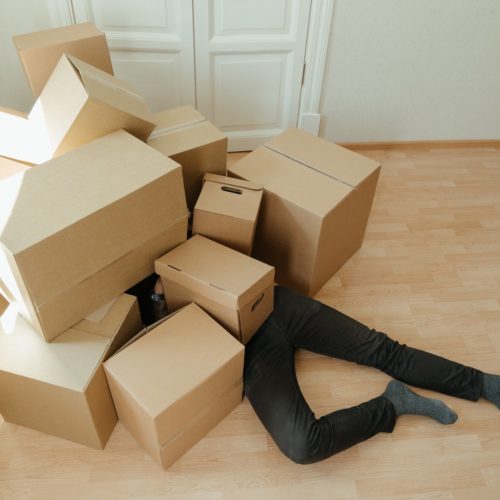 A person under boxes