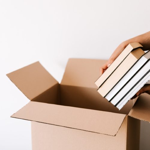 A person putting books in a box