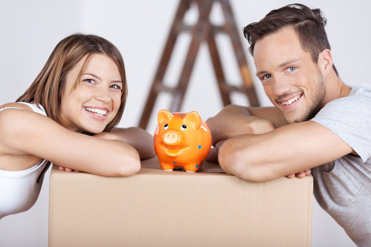 Couple with a piggy bank after moving cross-country