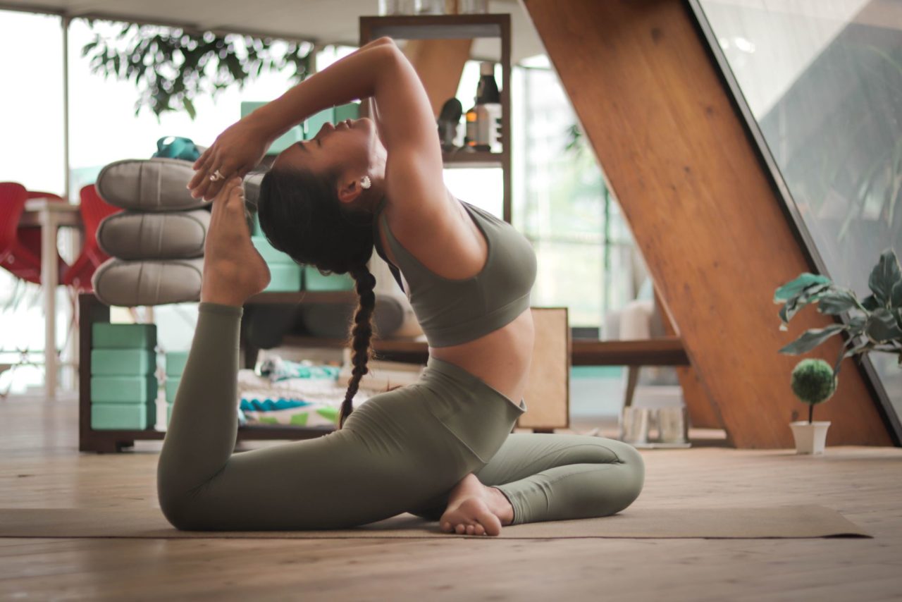 Girl practicing yoga at home