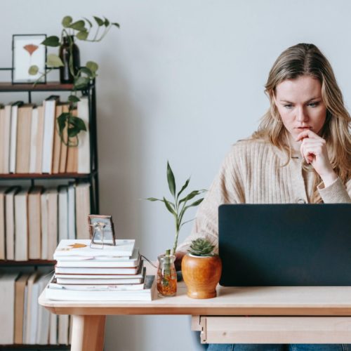 A woman checking long-distance movers on a laptop