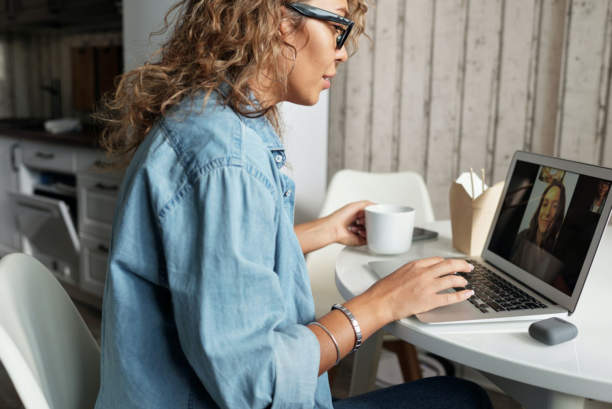 A woman having a video call on the laptop after cross-country moving