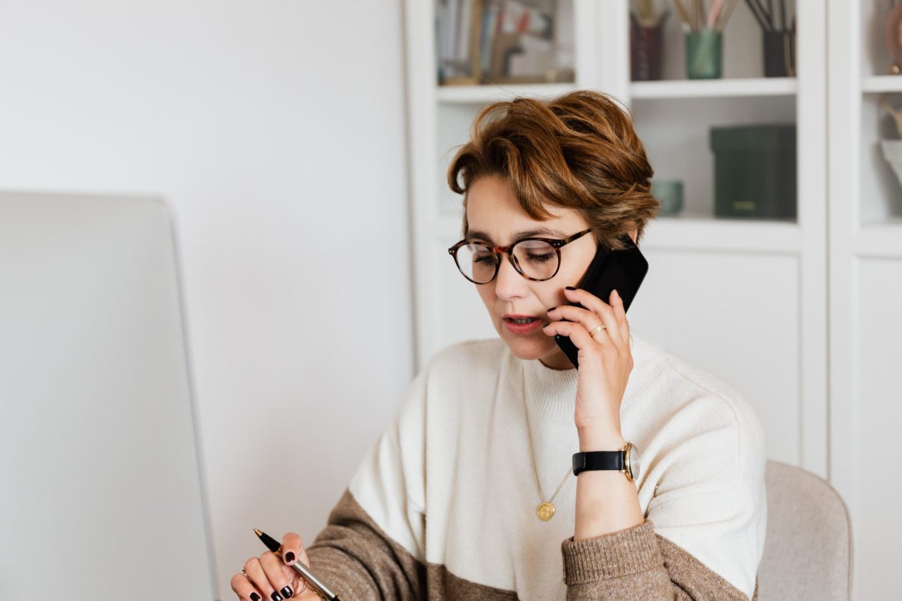 A woman talking on the phone with East Coast movers