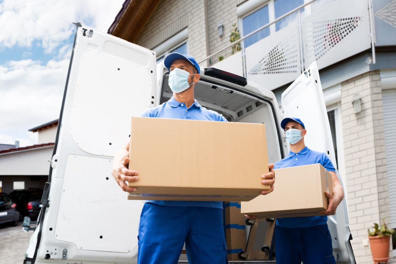 two movers with masks and boxes