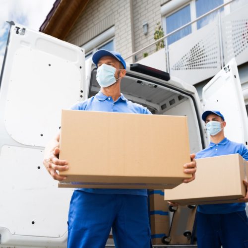 two movers with masks and boxes