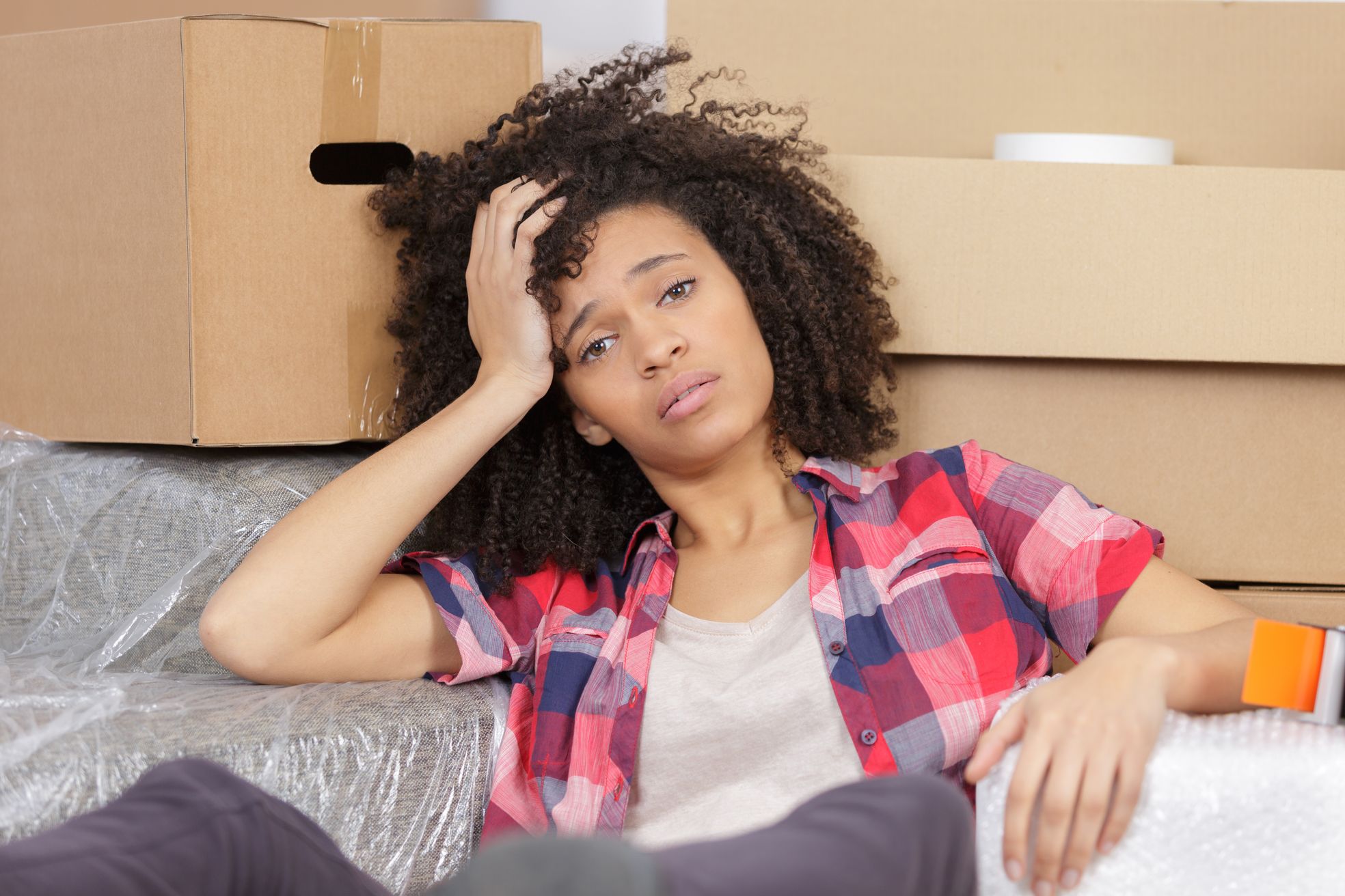 Girl thinking about what to keep for cross country moving