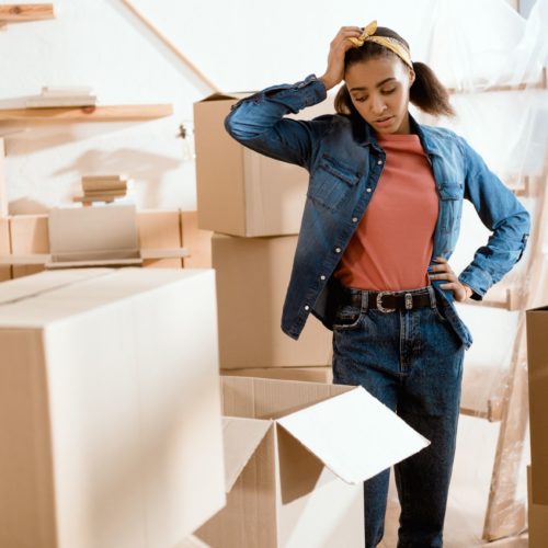 Girl packing boxes for cross country moving