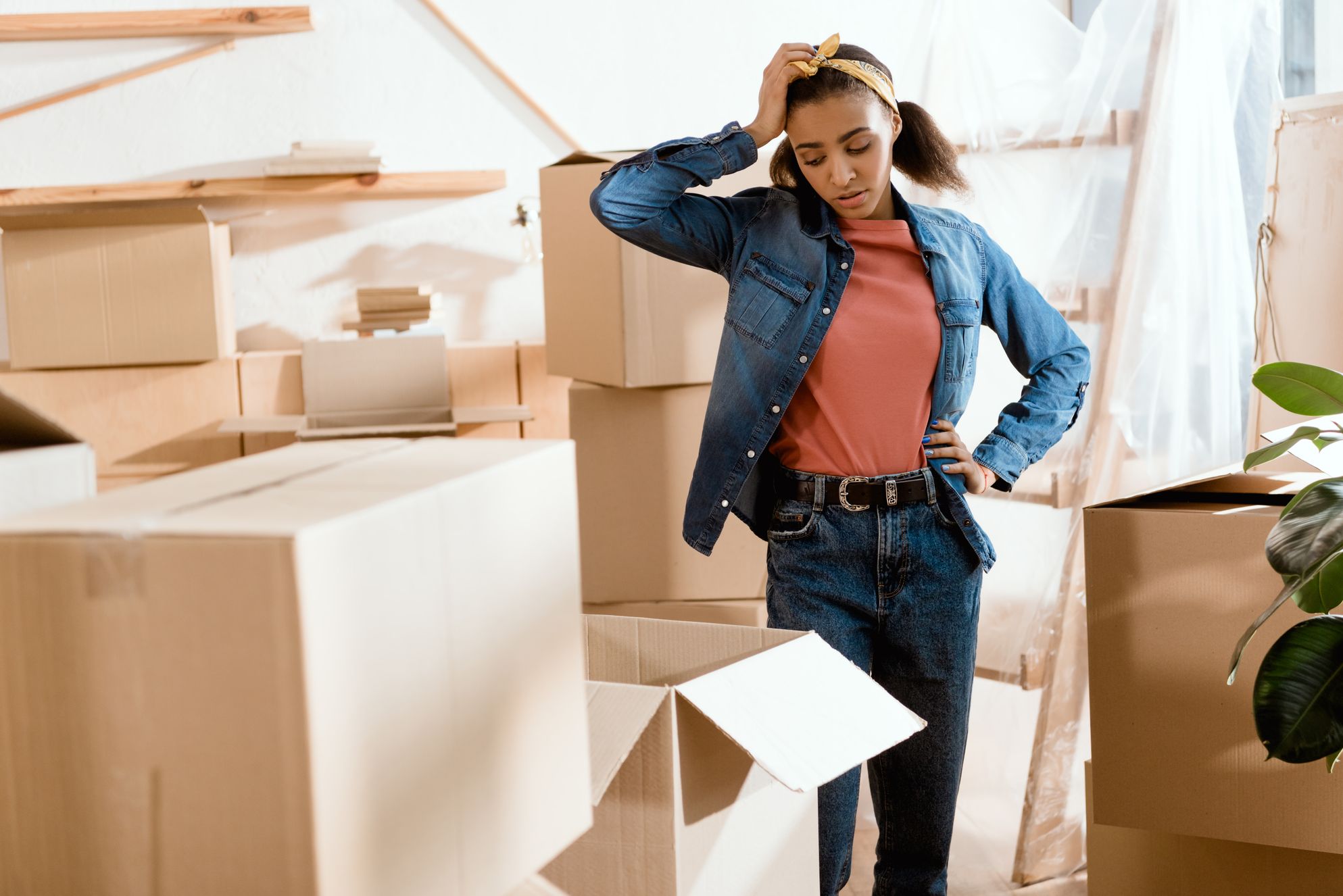 Girl packing boxes for cross country moving