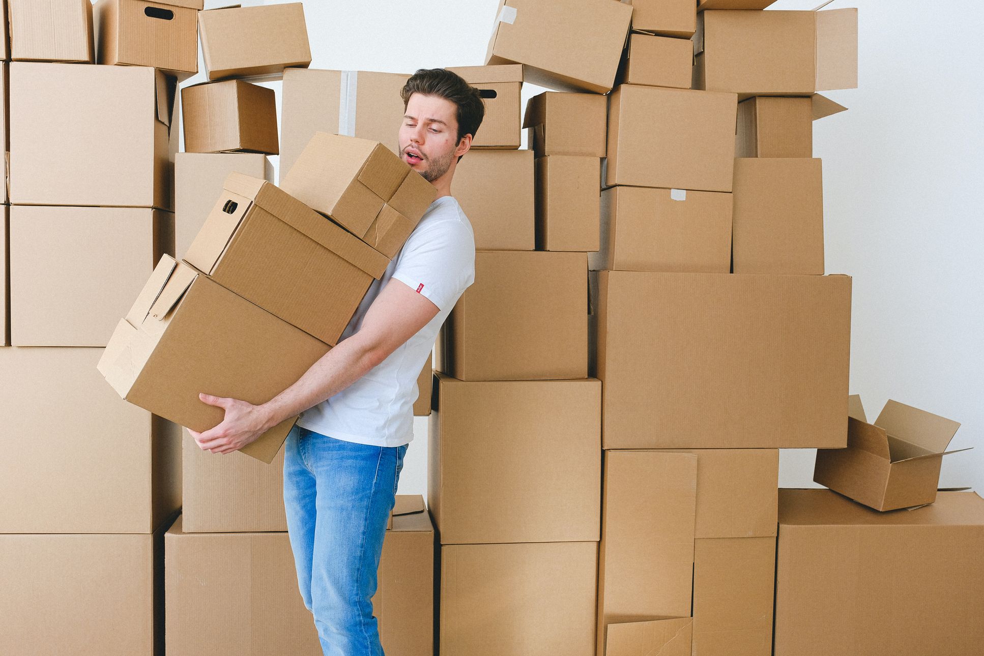 A man carrying boxes before the long-distance movers come