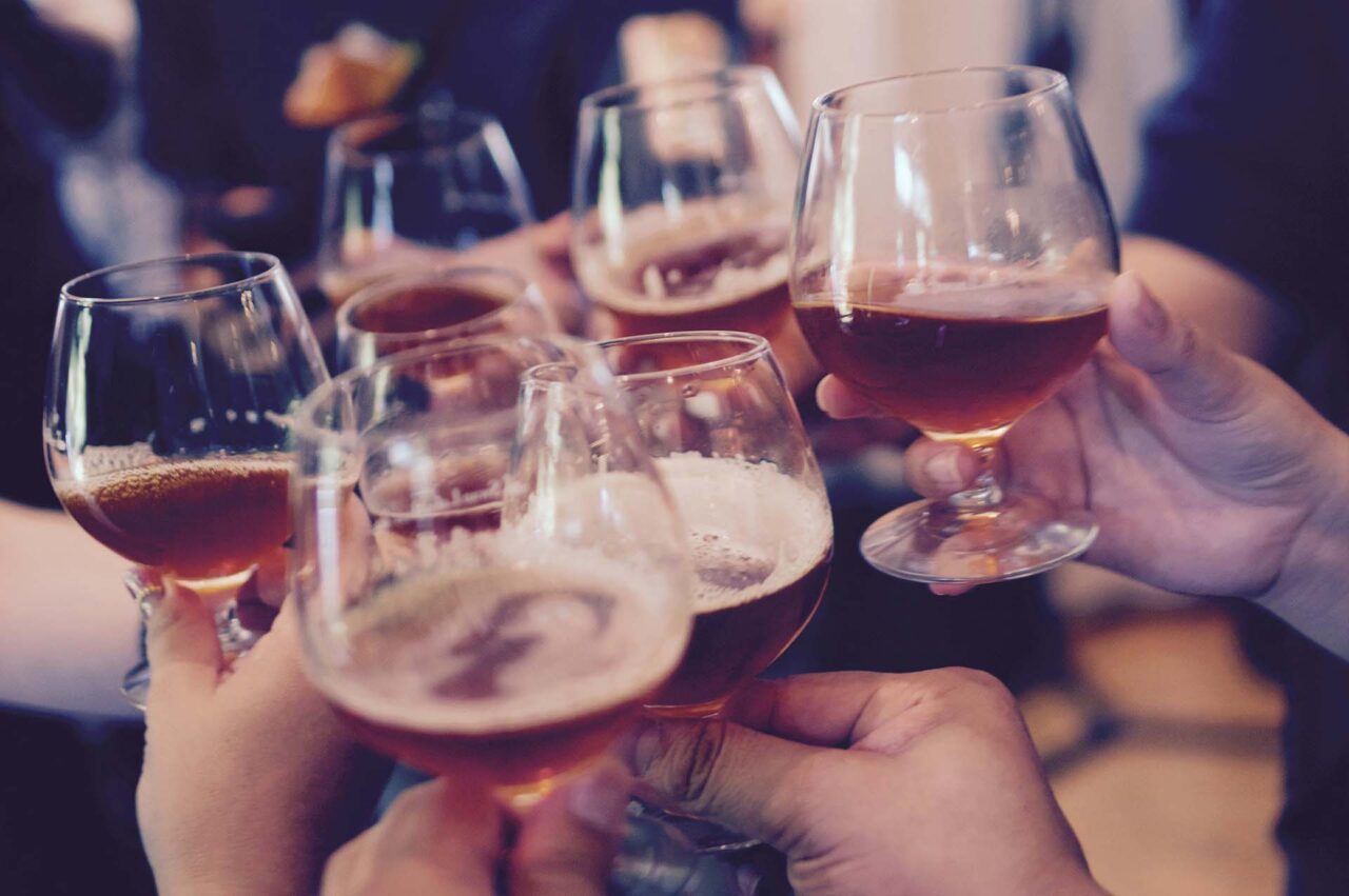 People cheering at a party while holding glasses