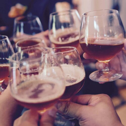 People cheering at a party while holding glasses